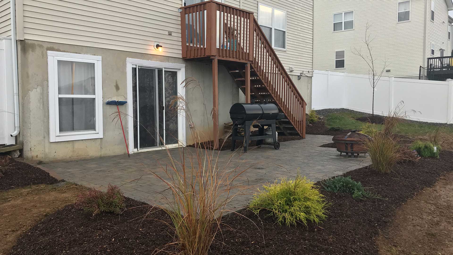 Home with a patio installed with landscaping maintained in Stewartsville, NJ.