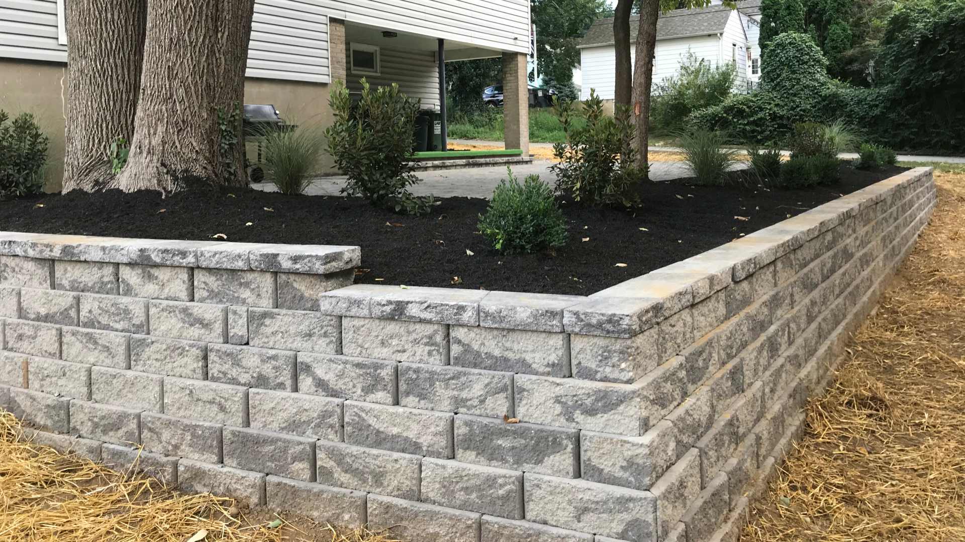 Retaining wall built out of stone pavers for landscape bed in Nazareth, PA.