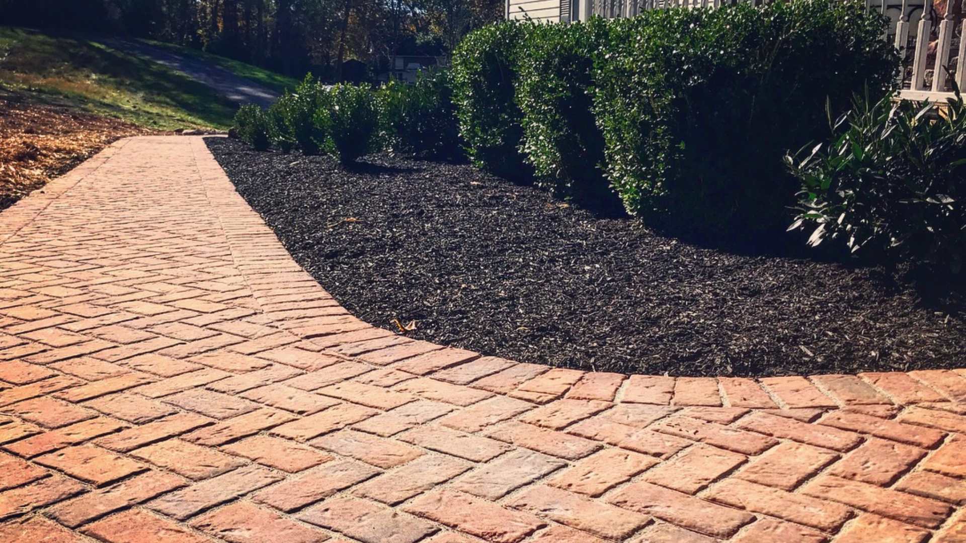 Brick paver walkway installed beside softscape bed in Easton, PA.