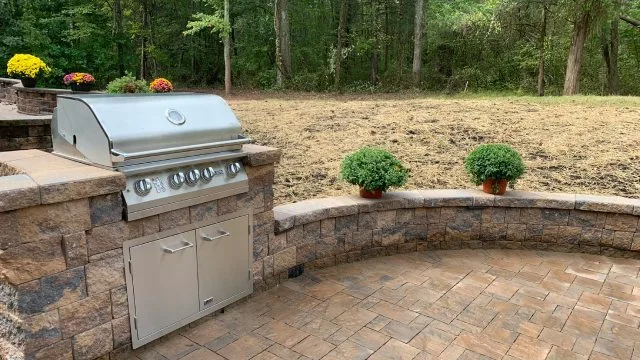 Outdoor kitchen with stainless steel grill installed for backyard in Clinton, NJ.