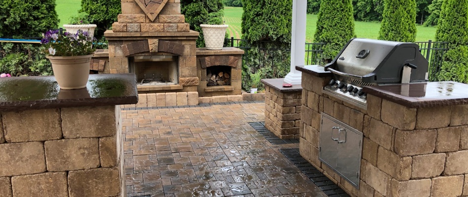 Outdoor kitchen built beside fireplace on patio in Nazareth, PA.