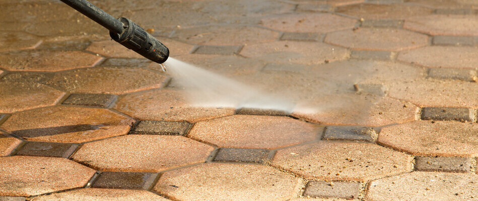 Close up on pavers being power washed on a property in Clinton, NJ.