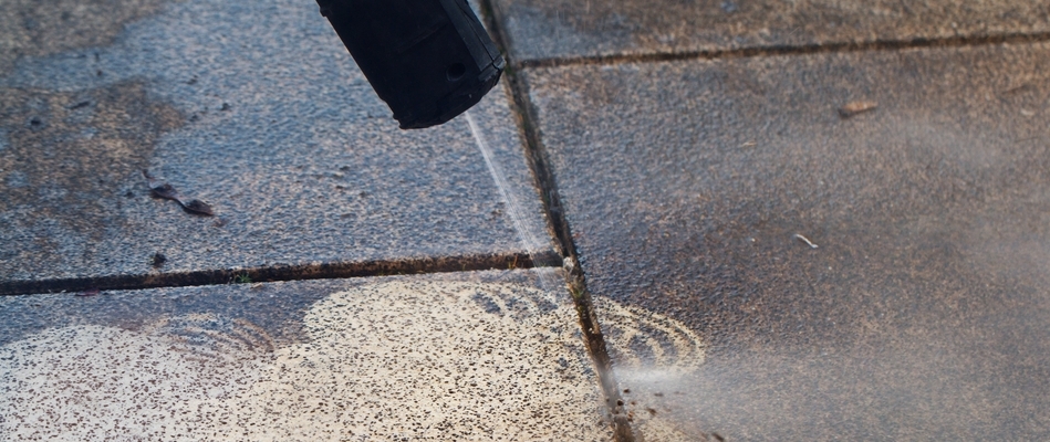 Close up on dirty pavers being sprayed by our professionals in Easton, PA.