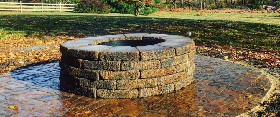 Stone paver fire pit installed on patio in Easton, PA.