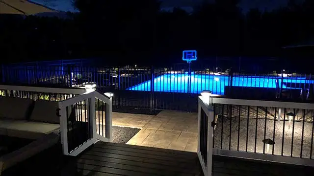 Landscape lighting installed around a pool in Clinton, NJ.